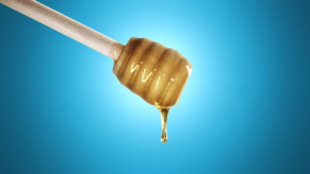 Honey dripping from honey dipper on blue background 4k