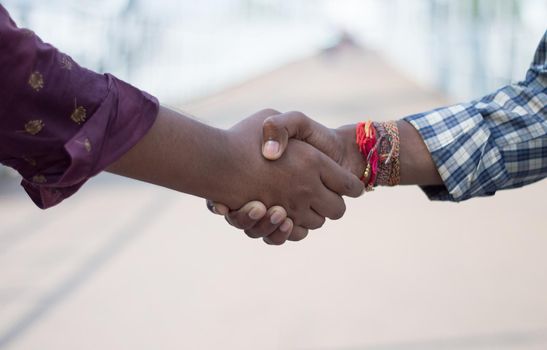 Friends shake hands. Closeup . Friendship handshake outdoor.