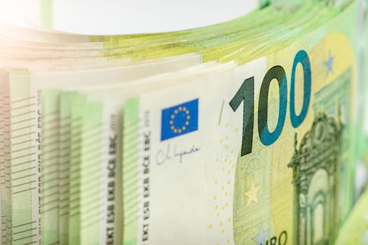 Close-up of a stack of paper bills, side view. Euro banknotes stacked on top of each other. Big pile of money