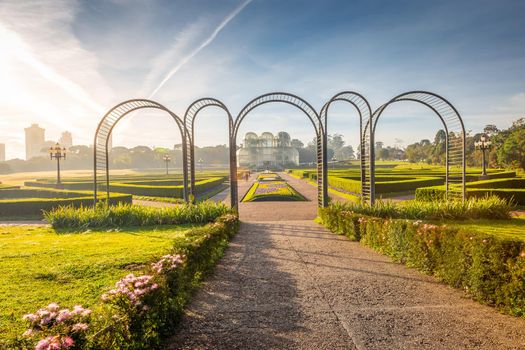 Public park around Botanical garden greenhouse in Curitiba at golden sunrise, Parana, southern Brazil