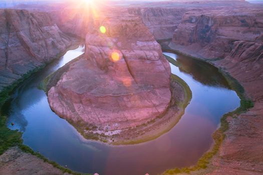 Horseshoe Bend above emerald Colorado River at sunset, Page, Arizona, United States