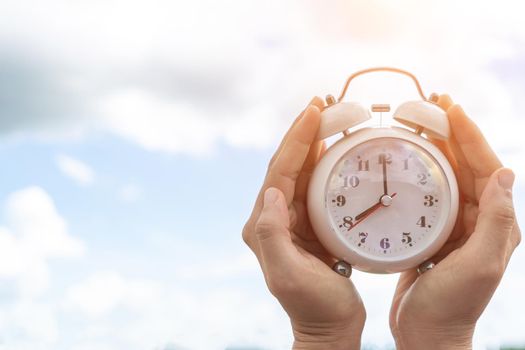 Selective focus of alarm clock with nature bokeh background. lifestyle  productive life concept.