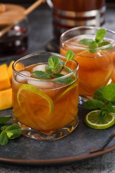 Mango iced tea with lime and mint. Refreshing organic soft drink