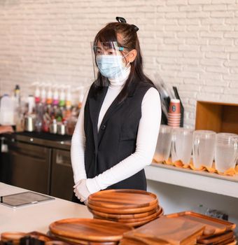 Coffee shop business owner wearing surgical mask.  Confident business  woman