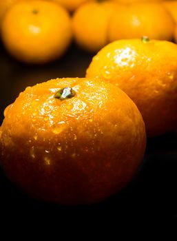 Close-up of Water droplet on glossy surface of freshness orange on black background