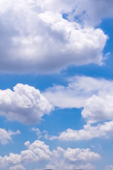 Fluffy clouds in the bright blue sky
