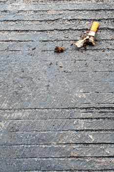 The cigarette butt let down on the concrete floor