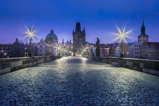 Charles bridge illuminated at dawn, Prague old town, Czech Republic