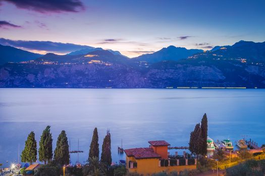 Above idyllic Lake Garda in Malcesine at dramatic dawn, Italian alps, long exposure
