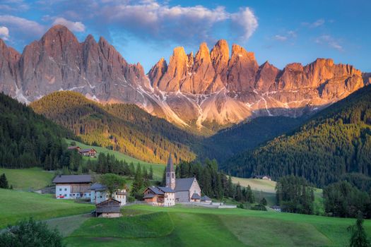 St. Magdalena village with famous church in Val di Funes at sunset, Dolomites , Italy