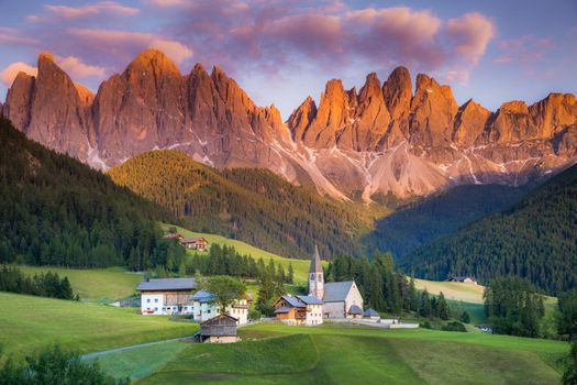 St. Magdalena village with famous church in Val di Funes at sunset, Dolomites , Italy