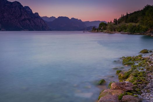 Above idyllic Lake Garda in Malcesine at dramatic dawn, Italian alps, long exposure