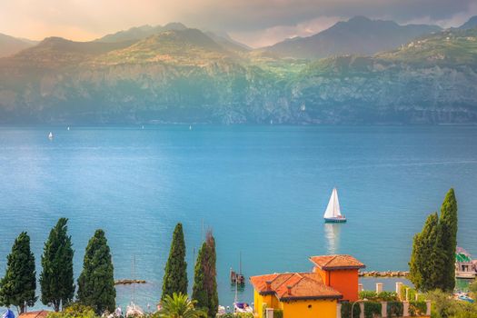 Above idyllic Lake Garda in Malcesine at dramatic sunset, northern Italian alps