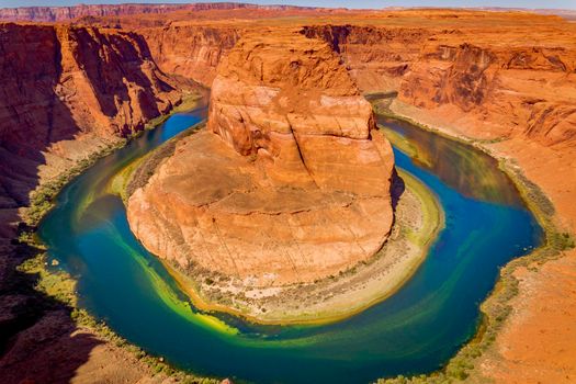 Horseshoe Bend above emerald Colorado River at sunset, Page, Arizona, United States