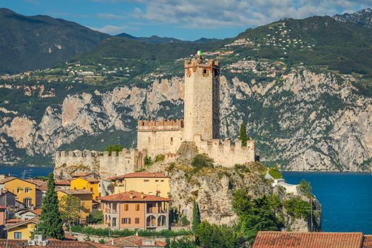 Lake Garda above Malcesine old town with Italian flag and mountain range