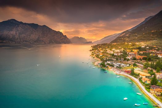 Above idyllic Lake Garda in Malcesine at dramatic sunset, northern Italian alps