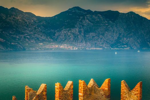 Above idyllic Lake Garda in Malcesine at dramatic sunset, northern Italian alps