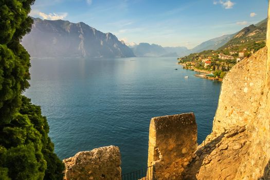 Above idyllic Lake Garda in Malcesine at dramatic sunset, Italian alps, long exposure