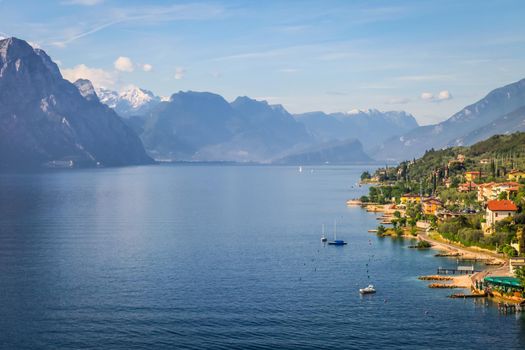 Above idyllic Lake Garda in Malcesine at brightly sunrise, Italian alps, long exposure