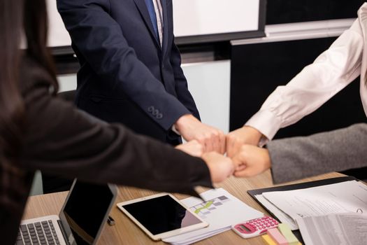 Business people join punching fists bump hands as team their meeting, Giving touch punch together of power teamwork, Business group winning successful company achieving goals with determined staff