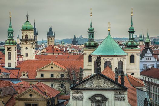 Above medieval Prague old town towers and domes at evening, Czech Republic