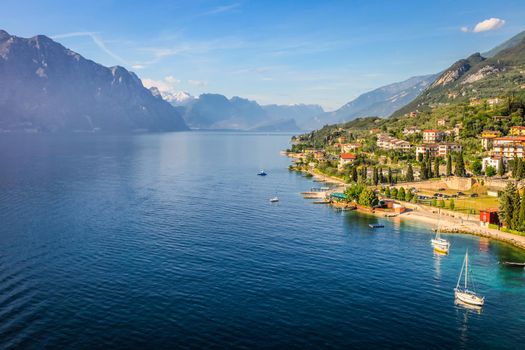 Above idyllic Lake Garda in Malcesine at brightly sunrise, Italian alps, long exposure