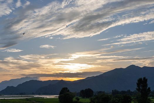 Colorful Sky At Sunset over a mountains and river