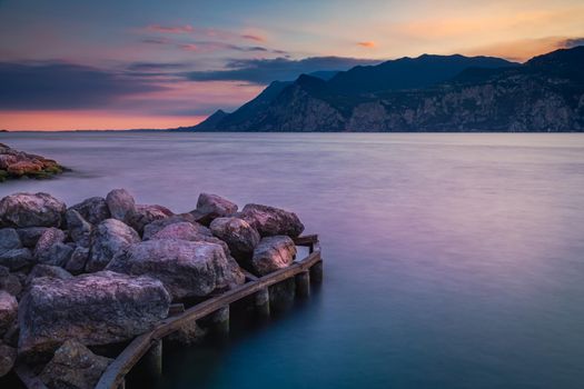 Idyllic Lake Garda in Malcesine at dramatic dawn, Italian alps, long exposure
