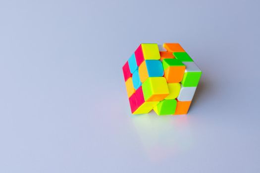 Rubik s Cube or 3D combination puzzle unsolved on an isolated white background with copy space