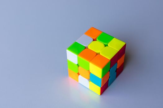 Unsolved rubik magic cube on a white isolated background