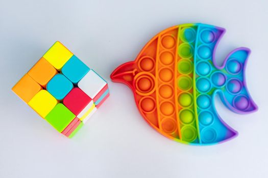 Puzzle cube and pop it silicon toys on a white isolated background