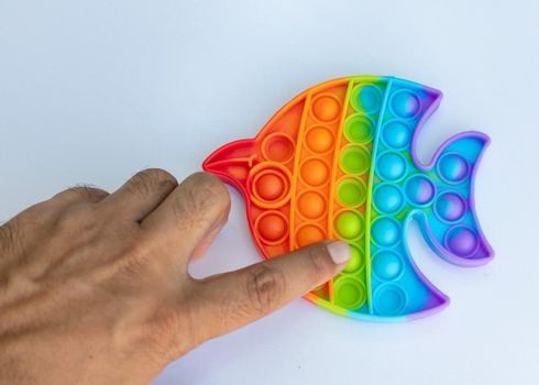 Man pushing pop It bubble fidget toys for anti anxiety and stress relief