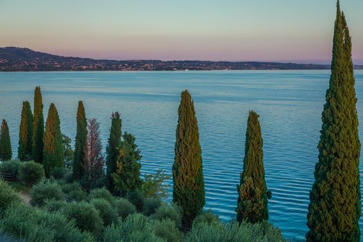 Idyllic lake Garda coastline in Lazise ar peacful sunset, Northern Italy
