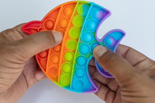 Playing colorful anti-stress sensory pop it game