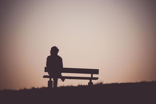 Silhouette of people sitting on the hill at dusk. Shooting Location: Mitaka City, Tokyo