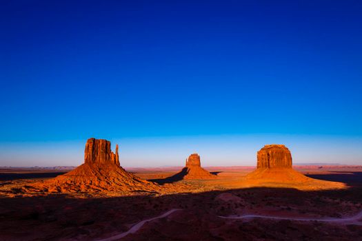 The Mittens, three buttes in Monument Valley at sunrise, Arizona and Utah, United States