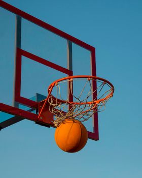 Basketball. The basketball ball hit the basket. This is a victory. Goal achievement and success. This is a win.