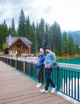 Emerald lake Yoho national park Canada British Colombia. beautiful lake in the Canadian Rockies during the Autumn fall season. Couple of men and women standing by the lake