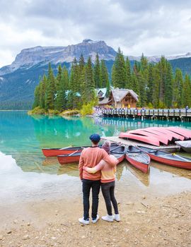 Emerald lake Yoho national park Canada British Colombia. beautiful lake in the Canadian Rockies during the Autumn fall season. Couple of men and women standing by the lake