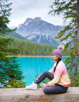 Emerald lake Yoho national park Canada British Colombia. beautiful lake in the Canadian Rockies during the Autumn fall season. Asian women looking out over Emerald lake