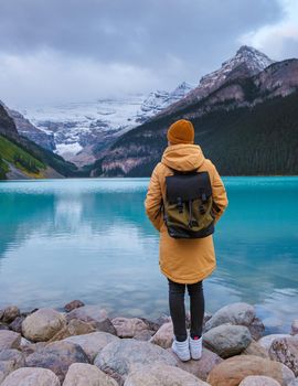 Lake Louise Canadian Rockies Banff national park, Beautiful autumn views of iconic Lake Louise in Banff National Park in the Rocky Mountains of Alberta Canada. young women standing by the lake