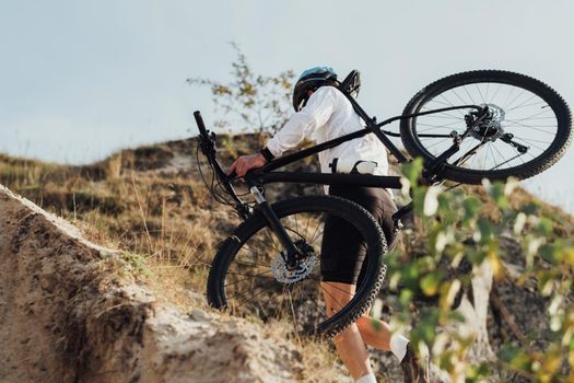 Professional Male Cyclist Carrying His Bike on Top of Hill, Adult Sportsman on Trail