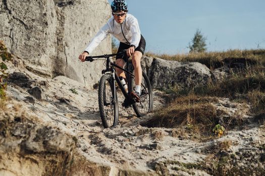 Equipped Professional Cyclist Descends a Slope on Mountain Bike, Sportsman Going Down from Hill on Bicycle