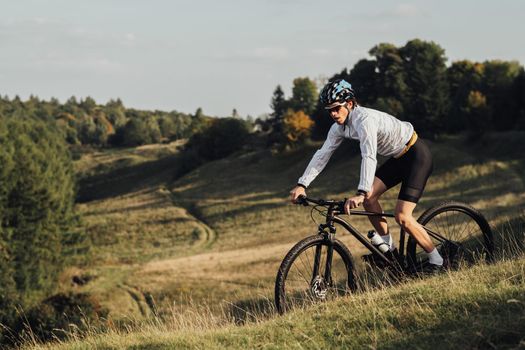 Professional Male Cyclist Riding Bike Outdoors, Adult Equipped Man on Bicycle on Trail, Copy Space