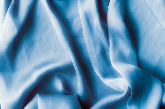 Blue soft silk waves, flatlay - elegant fabric textures, abstract backgrounds and modern pastel colours concept. Feel the touch of luxury