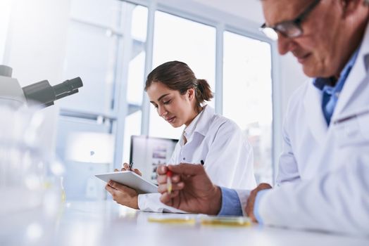 Advanced technology to help advance the sciences. two scientists working in a lab