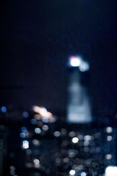 Blurry metropolitan district - night life, abstract background and modern dark tones concept. Big city comes alive at night