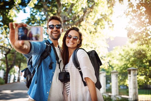 Travel makes us happy. an affectionate young couple taking selfies while out in a foreign country