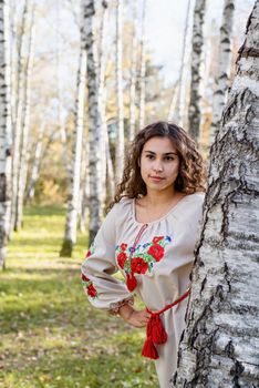 Indigenous people. beautiful woman in national ukrainian national traditional costume clothes walking in forest