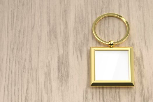 Square golden keychain on the wooden table